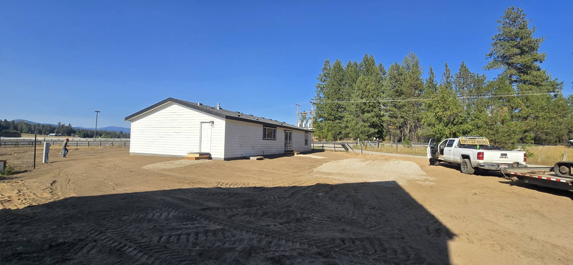 Completed home installation with finished dirt and gravel work