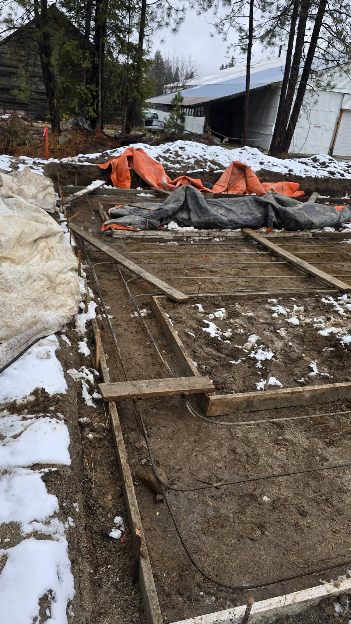 Foundation layout and concrete formwork on snowy site