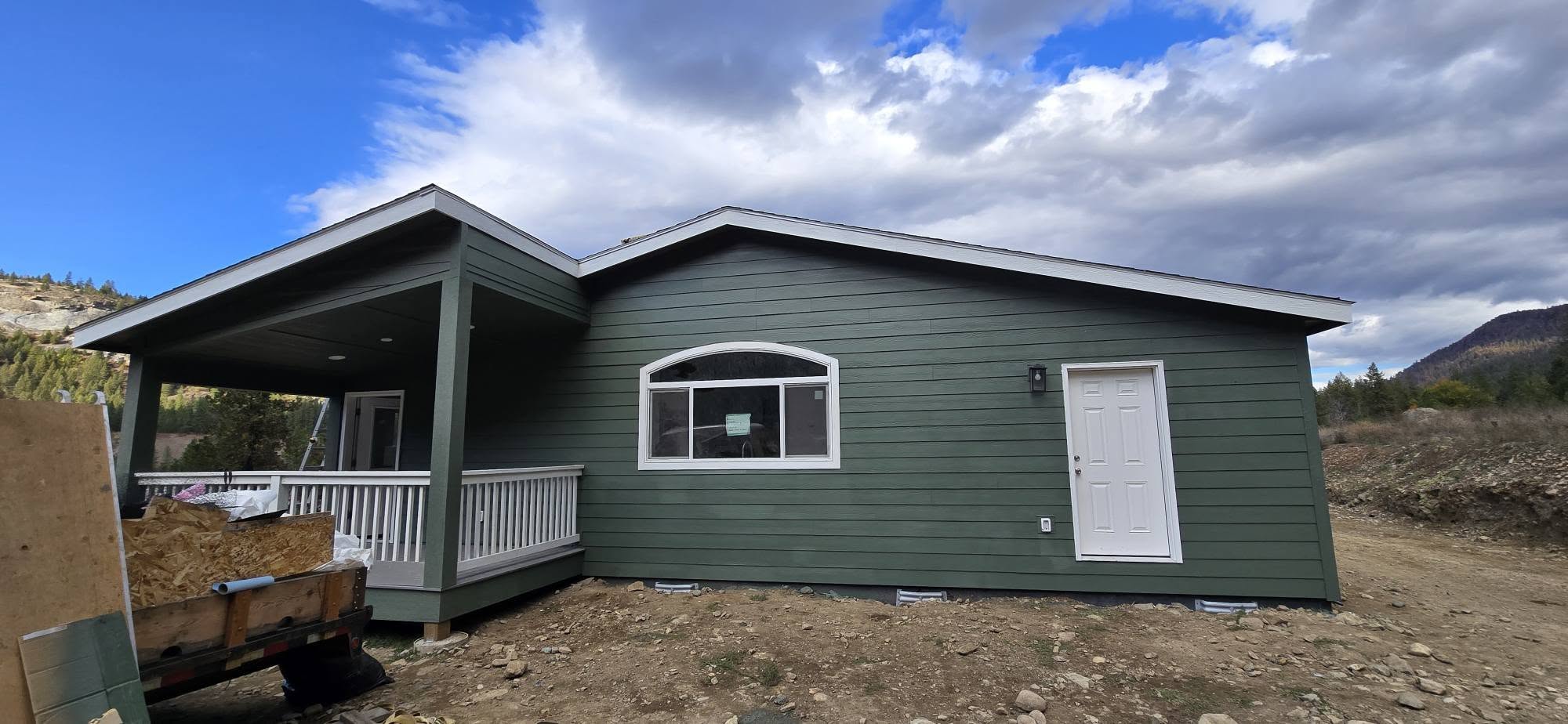 Completed green home exterior with covered porch